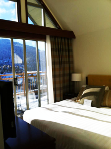 The bedroom's beautiful mountain view at the Pan Pacific Whistler Village 